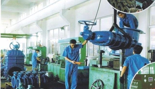 Large-caliber valve being lifted by crane for pressure testing at a customer's works