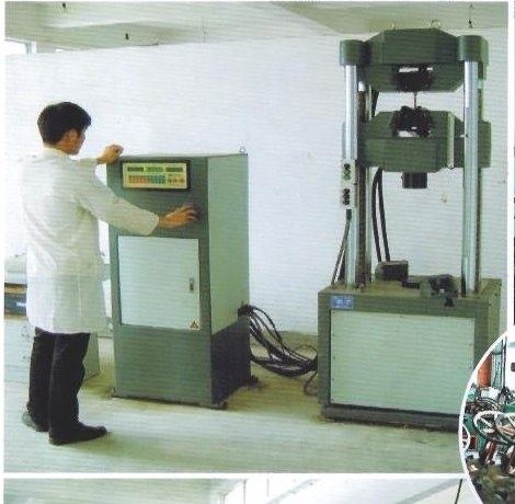 Operator running a vertical hydraulic valve test machine at a customer's works